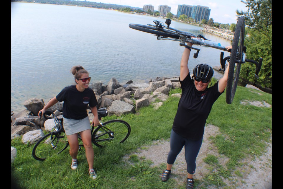 Julie Ann Chiodo, left, and Olivia Mendocino stopped in Barrie today for a quick rest at Heritage Park before continuing on toward Toronto. On July 8, they set out from Vancouver to raise money for the Canadian Pulmonary Fibrosis Foundation. Raymond Bowe/BarrieToday