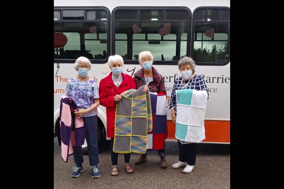 Betty Franklin, Elsie McGuire, Janet Powell and Jeanneke VanWesenbeeck, members of the knitting group at Waterford Barrie Retirement Residence, showcase four of the afghans they generously donated and delivered to Hospice Simcoe. Supplied photo