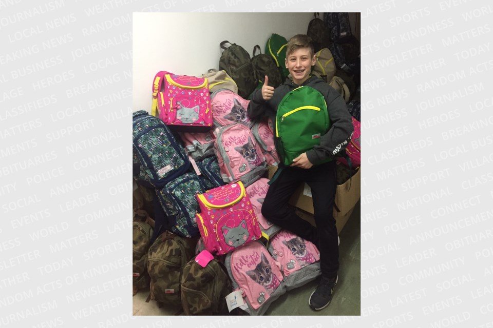 Oscar Oliver with backpacks for his Buy a Backpack campaign