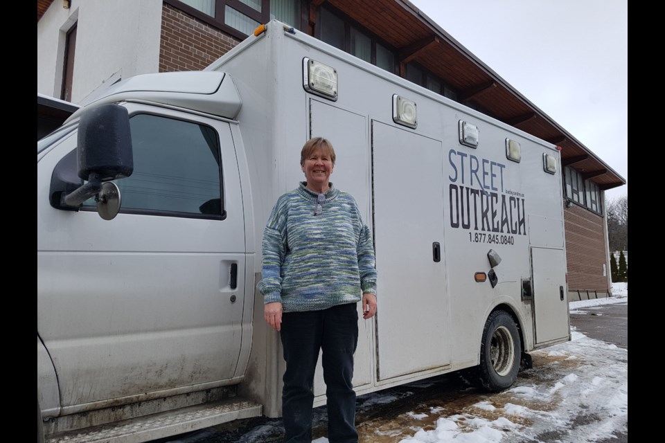 David Busby Street Centre volunteer Sue Petrie stands with the facility's Street Outreach truck outside the old Central United Church. Shawn Gibson/BarrieToday 