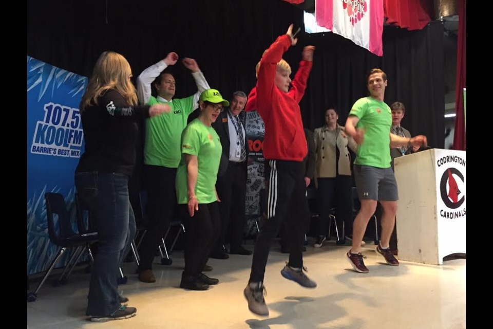 Zach Hofer helps his schoolmates warm up at the official launch of his Zach Makes Tracks fundraising run. 
Sue Sgambati/BarrieToday