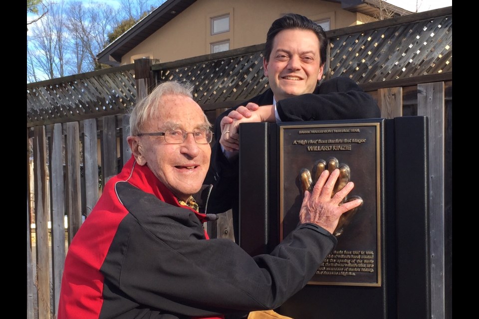 Barrie's first mayor, Willard Kinzie, gives a high-five to the cast of his hand while current mayor Jeff Lehman looks on in this file photo from December 2016. Sue Sgambati/BarrieToday