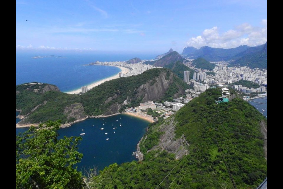 A view of part of Rio de Janeiro from Sugarloaf Mountain, with Copacabana Beach at the top and a much smaller beach below.