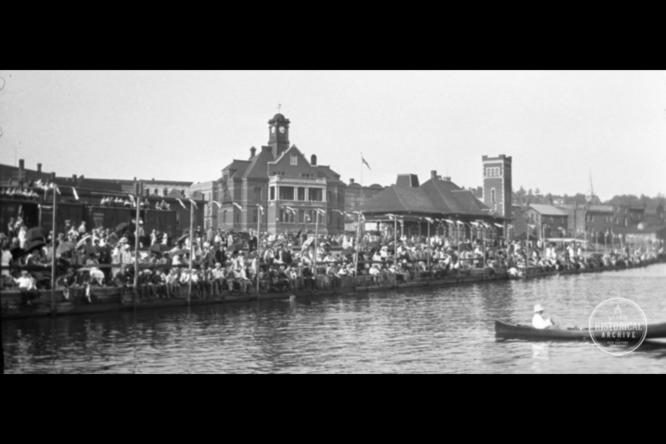 Spectators packed the waterfront, and some sat atop train cars, to watch the water sports.