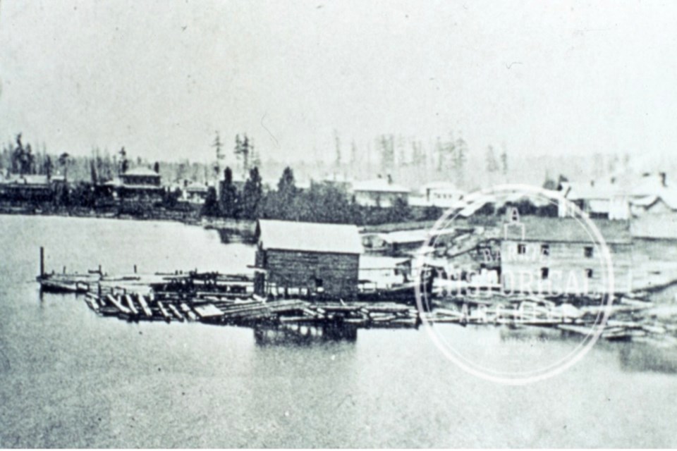 A photo of Fraser's Hotel (right), which stood on the eastern edge of present day Meridian Place, as seen in the early 1860s. A boathouse, wharf and the decaying hulk of the Beaver sit in the water to the south. 
