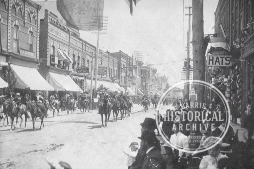 A well-attended parade on Dunlop Street East with an easterly view from Five Points. 