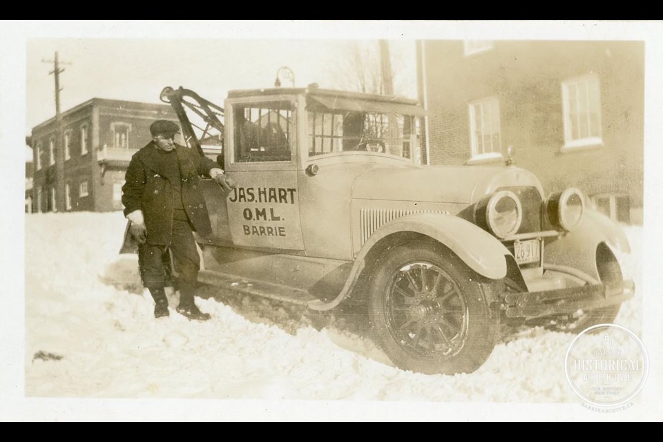 The first photo is of a James W. Hart Garage tow truck driver in 1928, Photo courtesy of Barrie Historical Archive. 