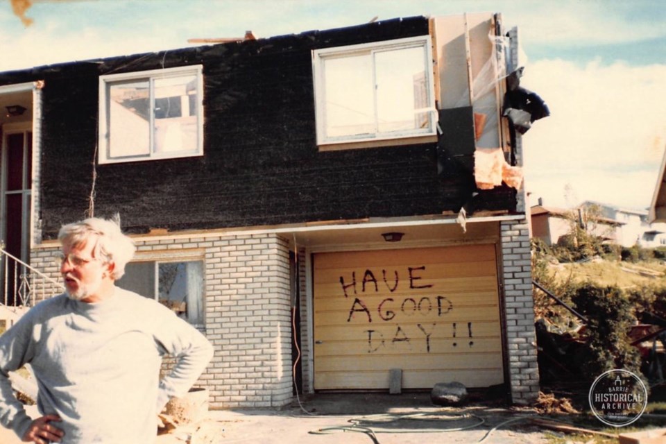 Terry Paddison in front of his heavily damaged Innisfil Street home. Barrie Historical Archive