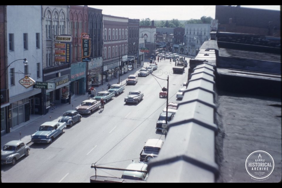 Looking west on Dunlop Street in 1959. The Laura Secord Shop on the south side of the street (white sign) is below the murder scene apartment. Photo courtesy of the Barrie Historical Archive