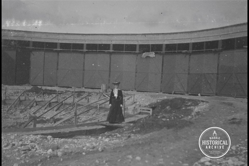 Mrs. Warren stands at the Allandale roundhouse under construction in 1904.