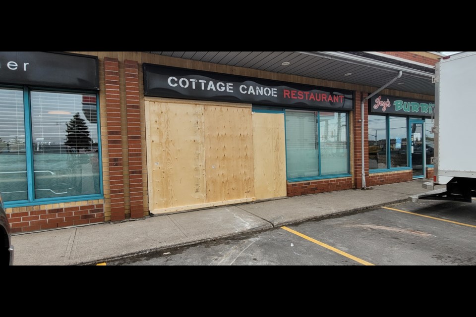 The window at the Cottage Canoe Restaurant at Dunlop Street West and Ferndale Drive is boarded up Monday morning after a car accidentally went through the window on the weekend. 