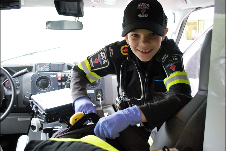 Sterling Lane, 10, packs up his gear in a Simcoe County ambulance. Jessica Owen/BarrieToday