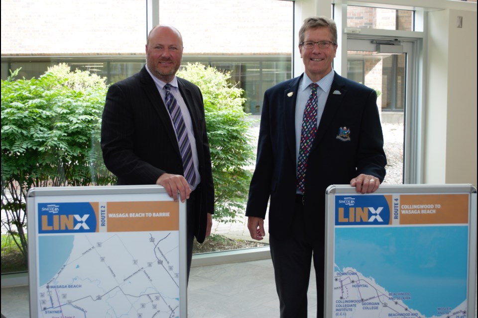 From left, Collingwood Deputy Mayor Keith Hull and Mayor Brian Saunderson show off the two new routes that will impact Collingwood residents the most. Jessica Owen/CollingwoodToday