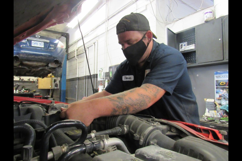 Devan Craft works away at his Craft Auto Repair Services shop and, when needed, will wear his protective mask. Shawn Gibson/BarrieToday                               