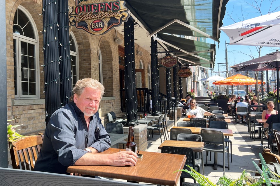 Jamie Humphreys enjoys the patio with a cold one on an unseasonably warm afternoon at The Queens on Dunlop Street on Saturday.