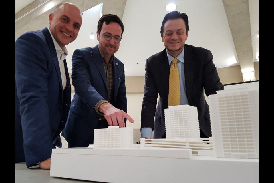 From left, HIP Developmens president Scott Higgins, Coun. Keenan Aylwin and Mayor Jeff Lehman look over the proposed development planned for the former Barrie Central Collegiate site in downtown Barrie during a public open house at Barrie City Hall on Tuesday, April 30, 2019. Shawn Gibson/BarrieToday