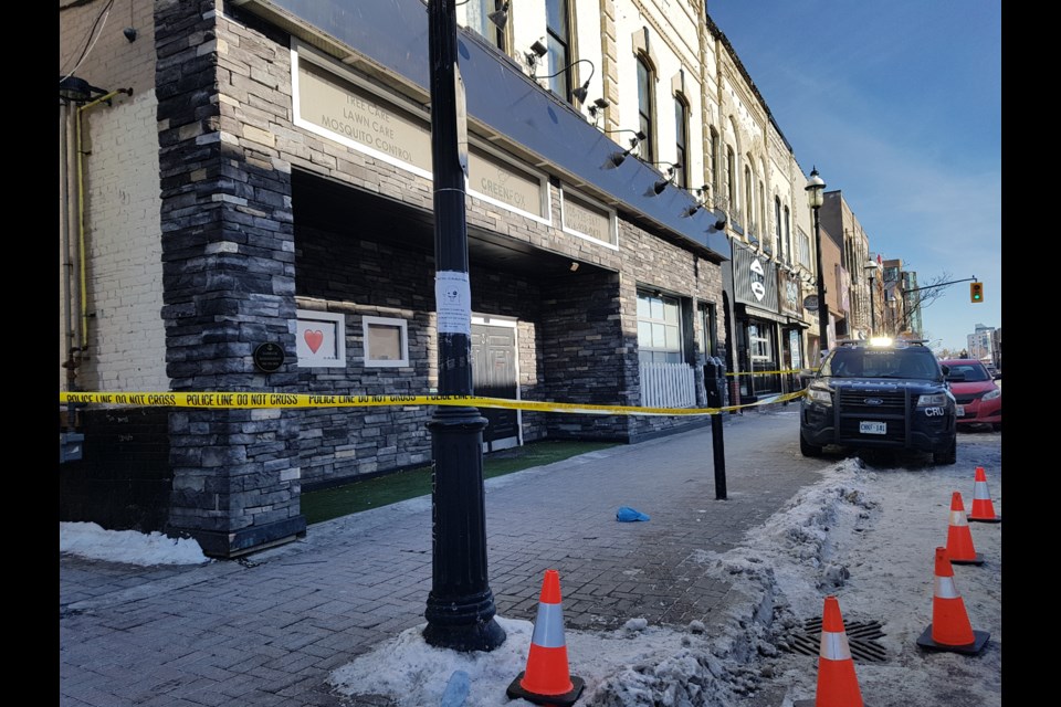 Police tape and police vehicles remain outside a downtown establishment as an investigation is carried out behind the businesses in the back alley-way, Saturday. Shawn Gibson/BarrieToday