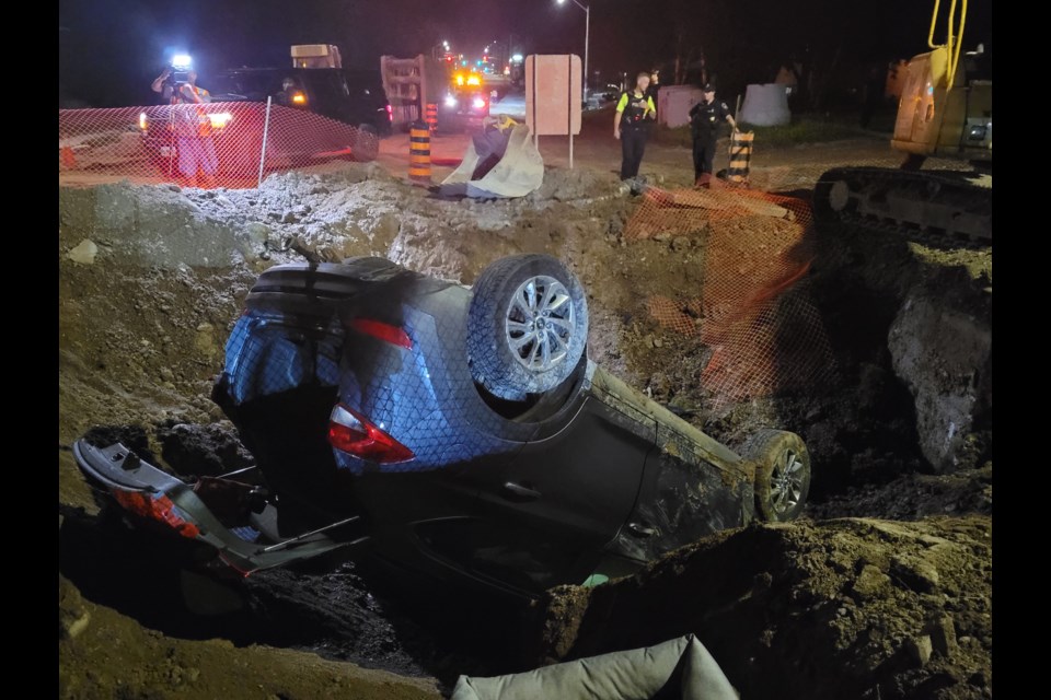 Barrie police investigate a crash at a Duckworth Street construction zone, Monday night. 
