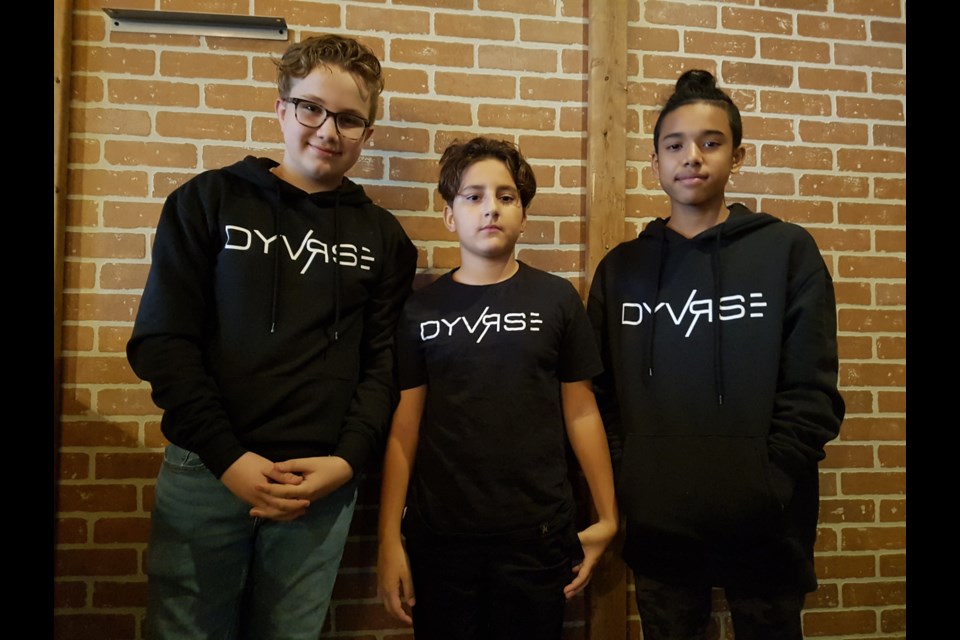 From left, Adam Harris-Hunwicks, Lucas Flammia, Cayden Segura show off their Dyvrse clothing line, which they hope will held finance their class trip to Ottawa. Shawn Gibson/BarrieToday