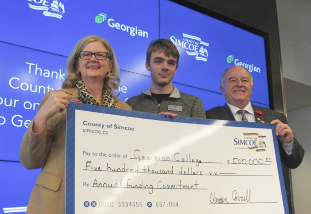 From left are Georgian College president and CEO MaryLynn West-Moynes, Jared Bergsma, County of Simcoe Warden George Cornell with a $500,000 cheque from the county. Shawn Gibson/BarrieToday