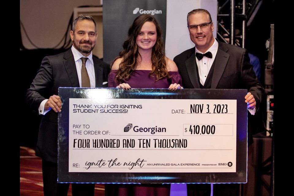 Georgian College graduates and gala co-chairs Ali Khonsari, left, and Addison Wallwin present a cheque for $410,000 to Georgian College president and CEO Kevin Weaver. Funds raised will support student awards, scholarships and bursaries, as well as the Georgian Food Locker, which provides emergency groceries to students in need.