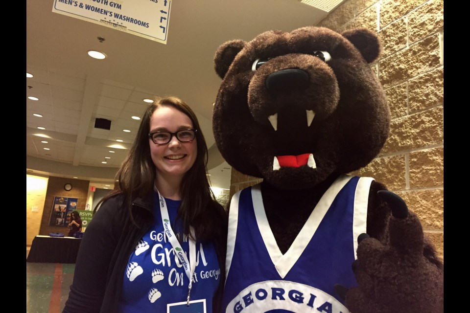 First year General Arts and Sciences student Rachel Osborne has her 'welcome students' smile as she poses with Georgian's mascot. 
Sue Sgambati/BarrieToday