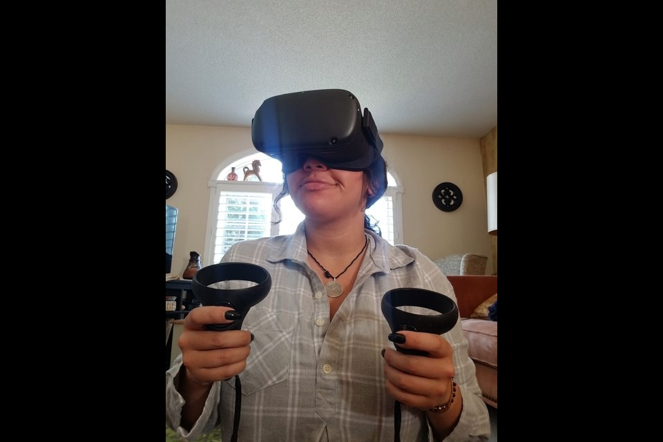 Maryam Ismail, a student in Georgian’s Anishnaabemowin and Program Development program uses her Oculus goggles to utilize the immersive virtual reality technology in the Indigenous Language House.
 