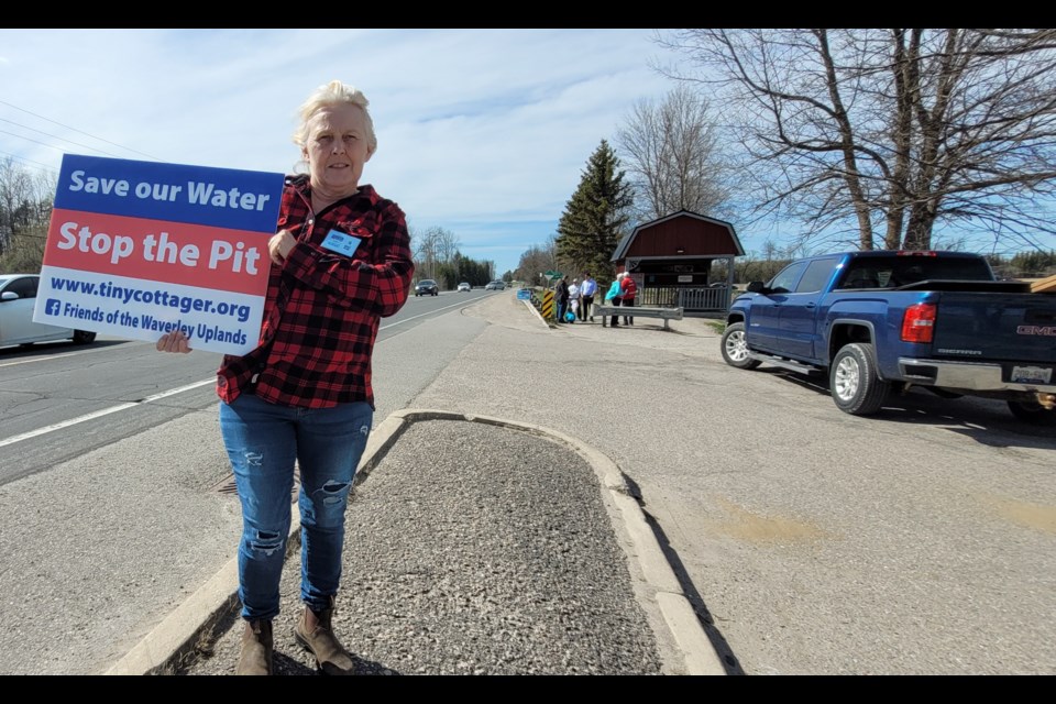 Lynne Gibson shows her concern for the disruption and destruction of the Elmvale Water Kiosk, Friday, May 6.
