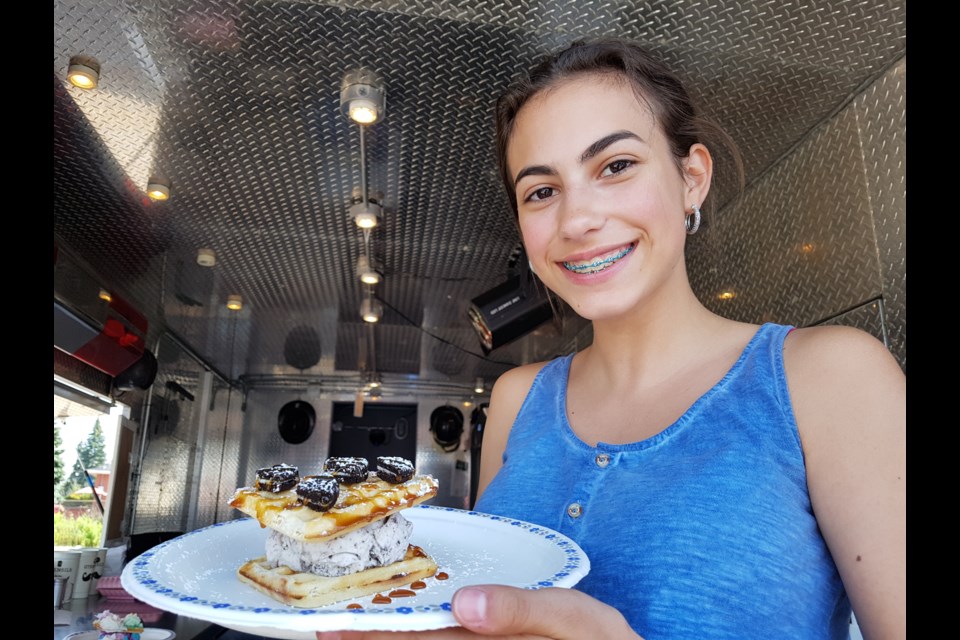 Emma Khan shows off one of the delicious summer treats her and her sister, Isabella, are serving up at Embella's, which is located at Yonge Street and Huronia Road. Shawn Gibson/BarrieToday