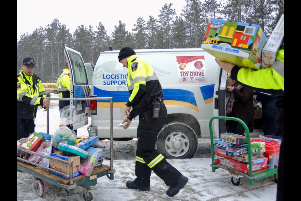 Paramedics and Simcoe County Museum staff load up toys for delivery to Christmas Cheer.
Sue Sgambati/BarrieToday          