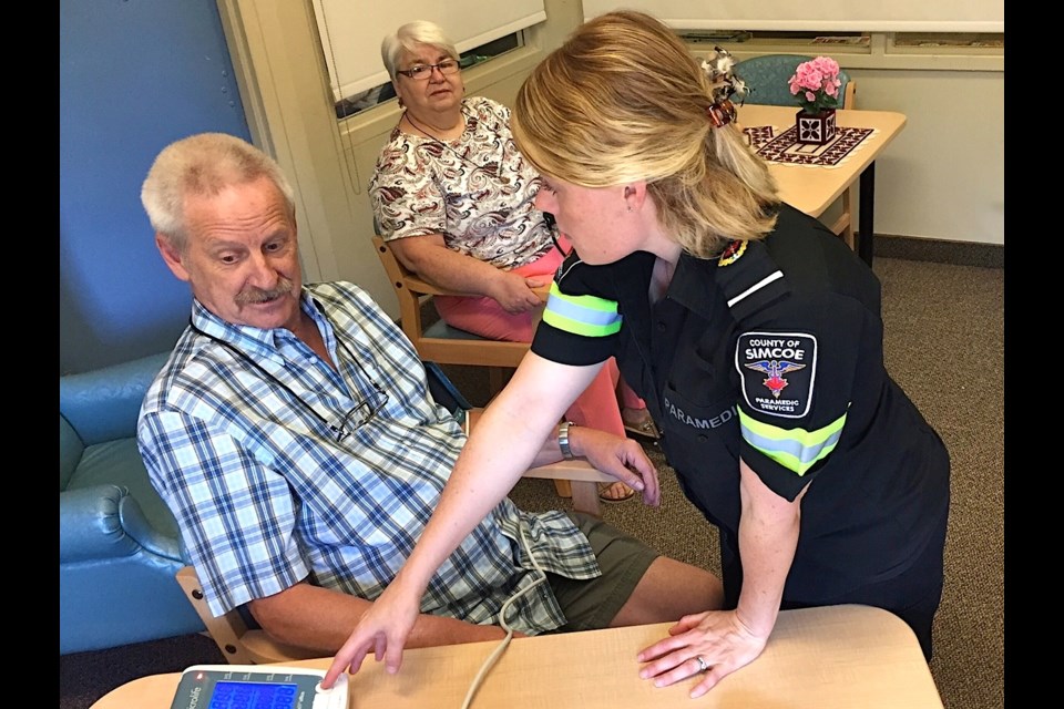 Simcoe County Paramedic Amanda Trebble checks up on patient John Maynard during a weekly wellness clinic for seniors  in Bradford.  
Sue Sgambati/BarrieToday