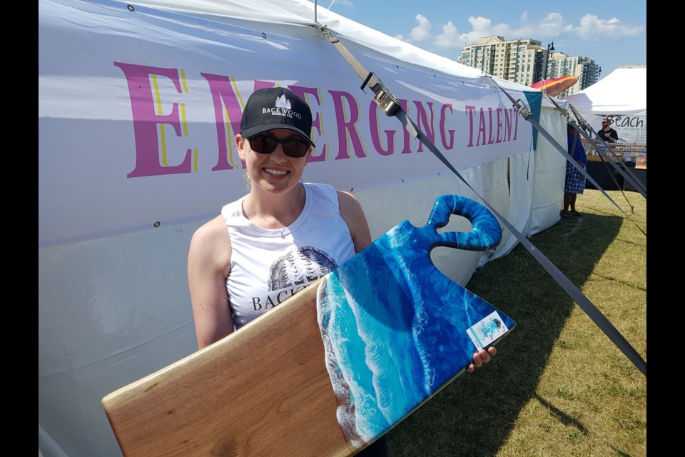 Lindsay Russell of Backwood Design Co. stands in front of the new Emerging Talent tent with her Georgian Bay line of cutting boards on Saturday August 3 2019. Shawn Gibson/BarrieToday