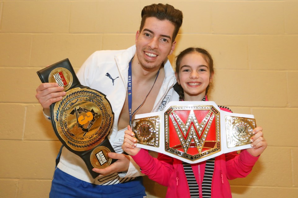 Three Pistols Champion, Alessandro Del Bruno, poses with eight-year-old Nives Sestak as she brought her own championship belt to the Barrie Wrestling match at the Ferris Lane Community Church in Barrie on Saturday, Jan. 20, 2018.  Kevin Lamb for BarrieToday