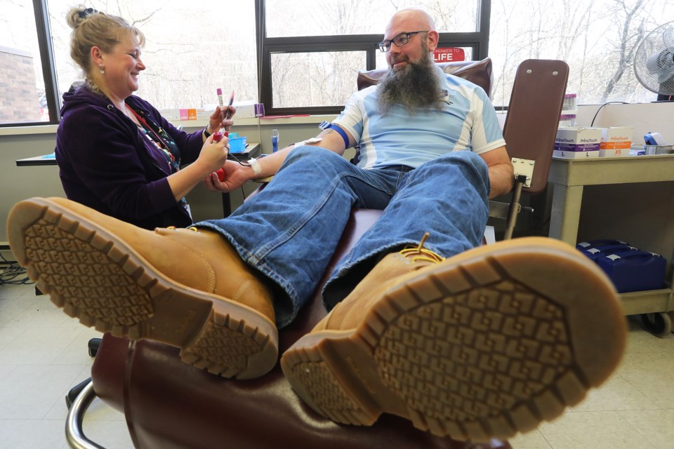 Donor Care Associate Cheryl-Lea Johnston gets ready to poke Colin Duffy of the Barrie Rugby Club as he takes part in the team's blood donation drive at the Barrie Blood Donor Clinic on Bayview Drive in Barrie on Good Friday on Friday, March 30, 2018. Kevin Lamb for BarrieToday.