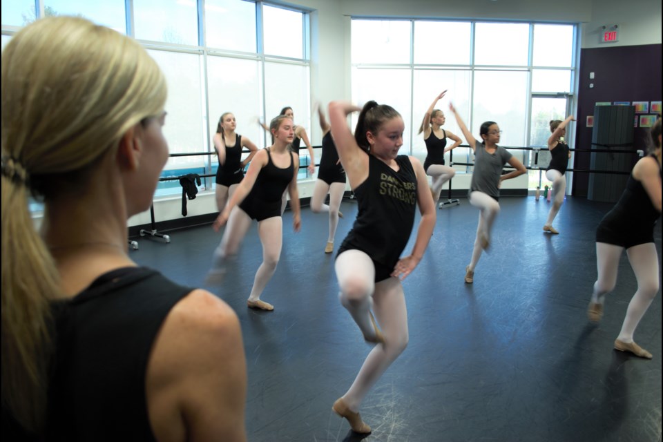 Wendy Wood, left, watches her teen class practise for Dance Incorporated's 25th anniversary recital, taking place May 25 and 27 at Georgian College Theatre. Jessica Owen/BarrieToday