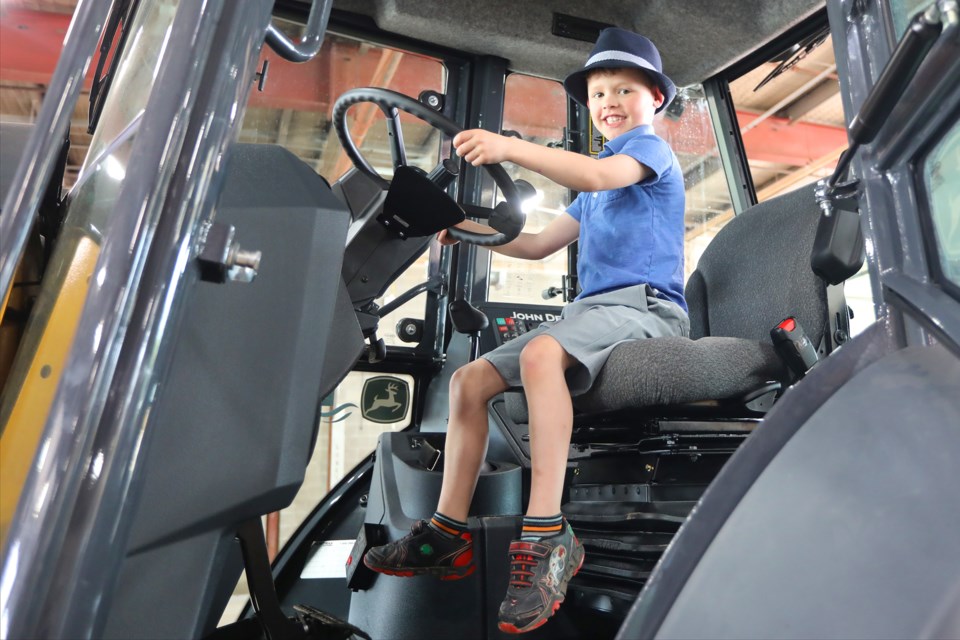 Five-year-old Deacon Manuel checks out a backhoe while visiting the National Public Works Week event that the city hosted at the Operations Centre on Ferndale Drive on Saturday, May 26, 2018. Kevin Lamb for BarrieToday.
