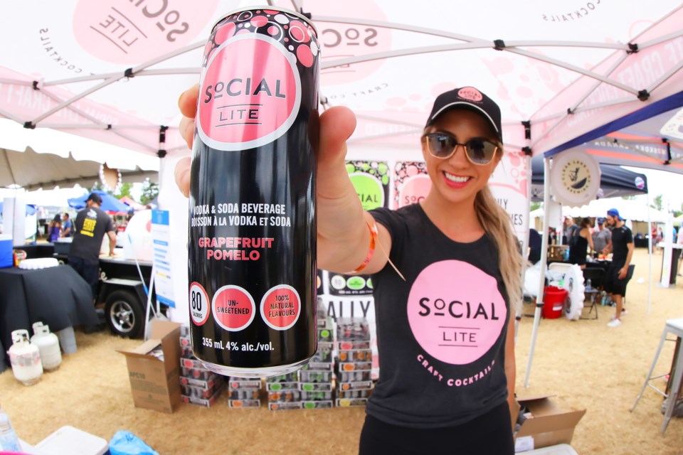 Amanda Svab of Social Lite offers up a cold one at the Medley Food & Drink Festival near the Southshore Centre in Barrie on Saturday, July 21, 2018. The festival continues through Sunday. Kevin Lamb for BarrieToday.