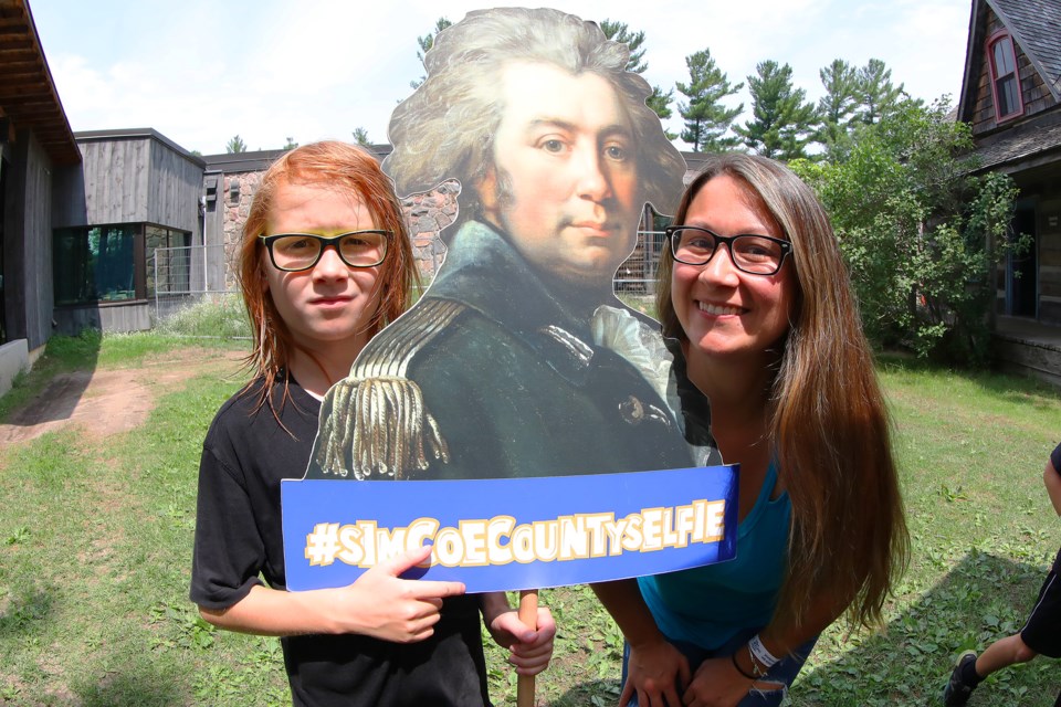 Liam and Erin Sato pose with a cutout of John Graves Simcoe, who was the first Lieutenant Governor of Upper Canada and a founding figure in Canadian history, at the Simcoe County Museum during their Simcoe Day event. The event celebrated the county's programs and picnic-themed activities on Monday, August 6, 2018. Kevin Lamb for BarrieToday.