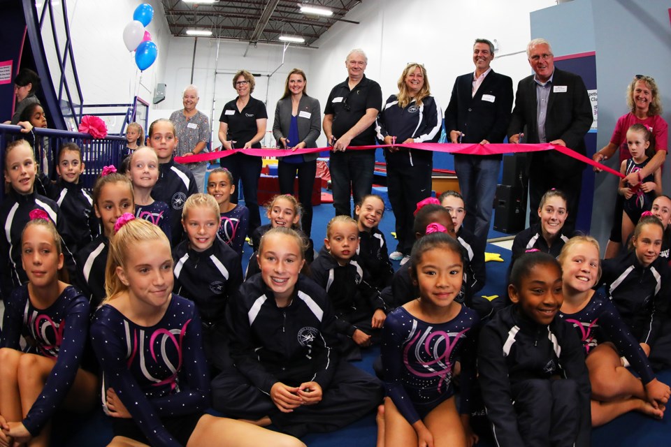 Dignitaries and members of the Barrie Kempettes Gymnastics Club celebrate the grand opening on Saturday of a new section at their location on Welham Road called Flipside. Kevin Lamb for BarrieToday.