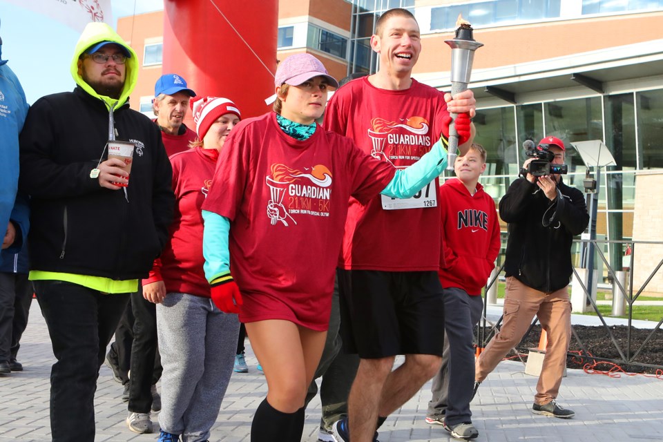 Special Olympians carry the torch at the start of the Guardians Half Marathon in Orillia on Sunday, October 14, 2018. Kevin Lamb for OrilliaMatters.