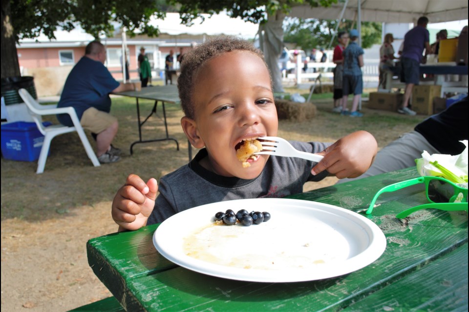 Teegan Christie, 3, enjoys a big bite of blueberry pancakes during the Blueberry Pancake Festival on Saturday. Jessica Owen/BarrieToday