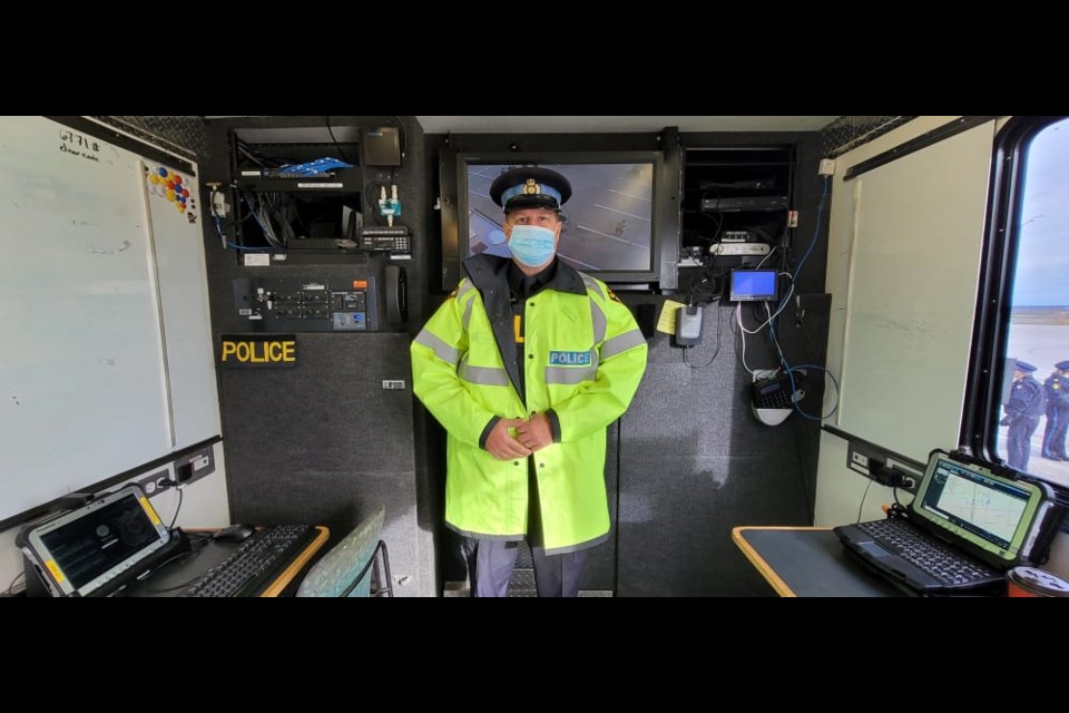 OPP Const. Jack Harrison stands inside provincial police's mobile command vehicle, which can be used for testing suspected impaired drivers at the scene.