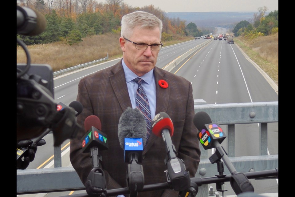 OPP Commissioner Vince Hawkes stands on an overpass with the scene of Tuesday's massive fireball collision in the background on Highway 400.
Sue Sgambati/BarrieToday        