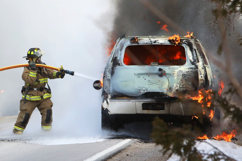 A Township of King firefighter battles a vehicle fire on Keele Street at Davis Drive West near Newmarket just before 5pm on Thursday, April 19, 2018.  Kevin Lamb for BarrieToday.