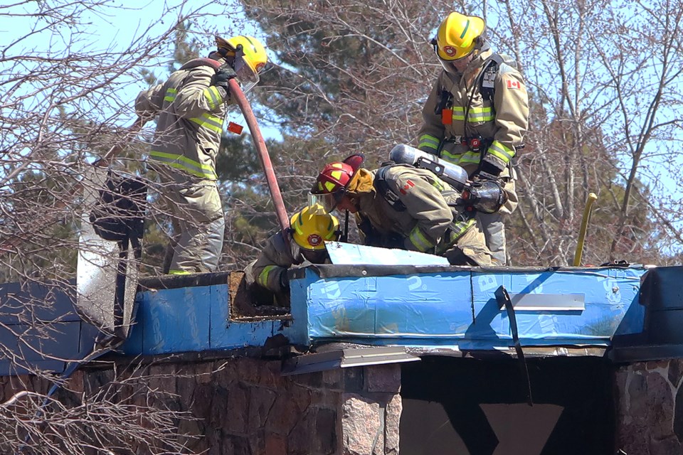 Springwater fire crews try to get at a stubborn fire in the wall and roof of the Simcoe County Museum on Saturday, April 21, 2018.  Kevin Lamb for BarrieToday