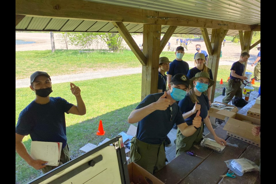 Squadron 102 Level 4 cadets prepping MREs, or meals ready to eat.