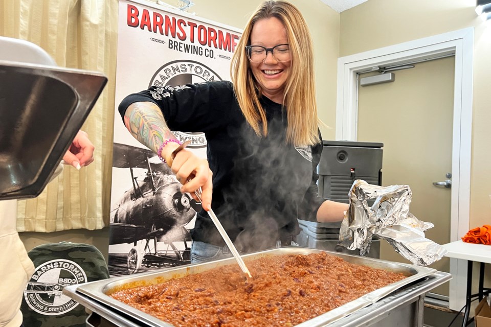Dani Maes, of Barnstormers Brewing Company, gives the chili a good luck stir just prior to the start of the chili cook-off at the Army Navy Air Force (ANAF) Club on Morrow Road in Barrie, hosted by the 102 Barrie Air Cadet Squadron on Saturday. | Kevin Lamb for BarrieToday