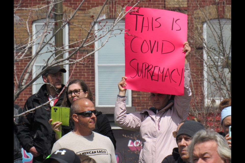 Attendees show how they feel oppressed by the virus during a rally on Saturday at Meridian Place in downtown Barrie. 
