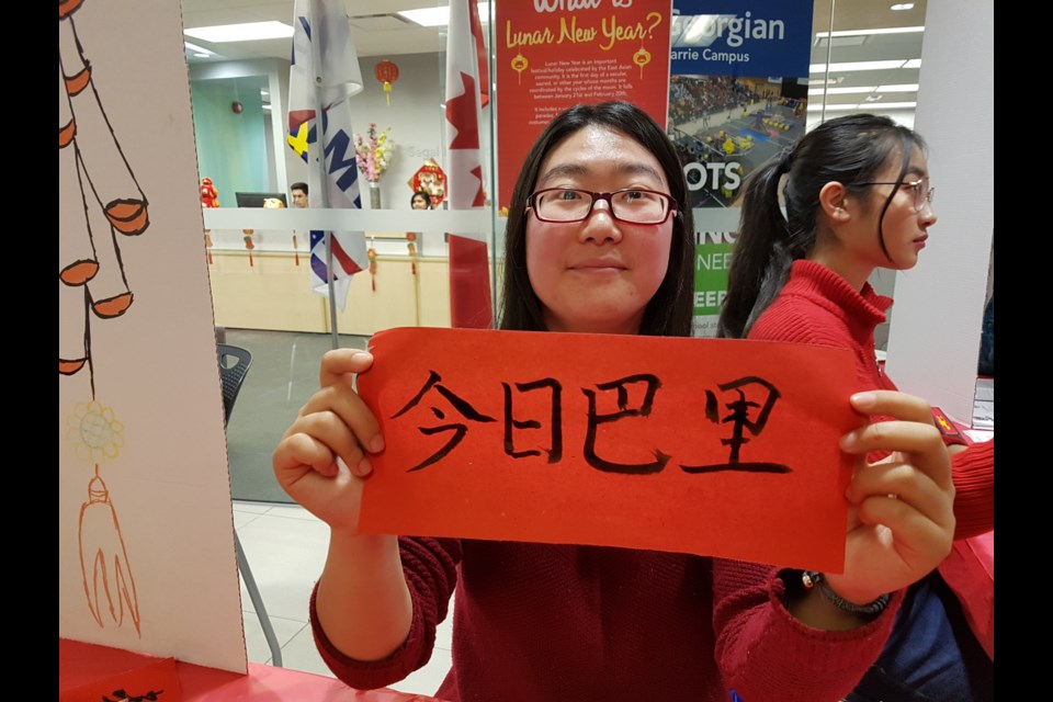Yue You shows what BarrieToday looks like when written in Chinese. Shawn Gibson/BarrieToday   