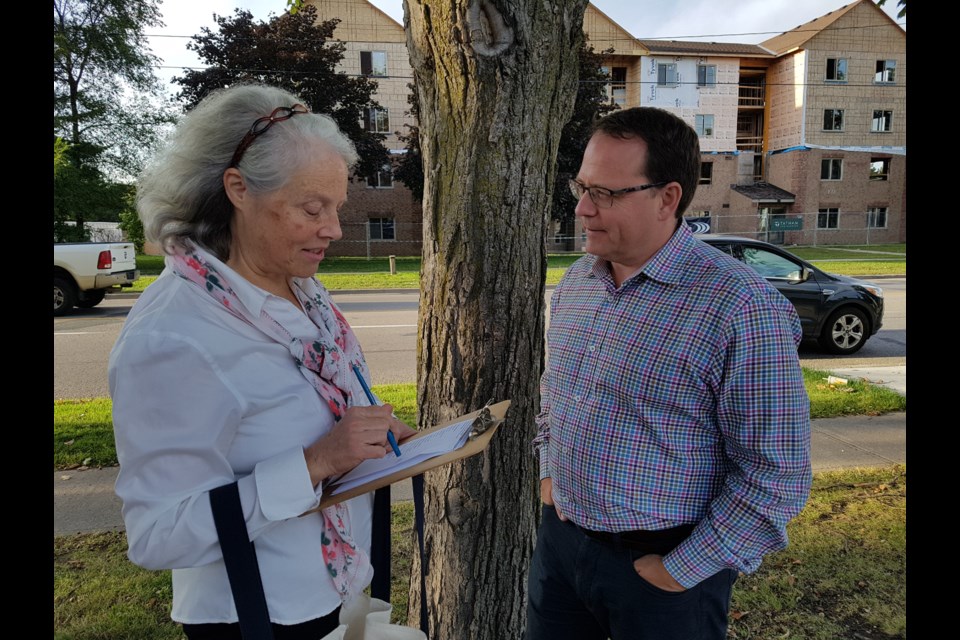 Barrie-Innisfil Green Party candidate Bonnie North (left) and leader of the Ontario Green Party Mike Schreiner discuss campaigning along Little Avenue in south-end Barrie, Thursday evening. Shawn Gibson/BarrieToday